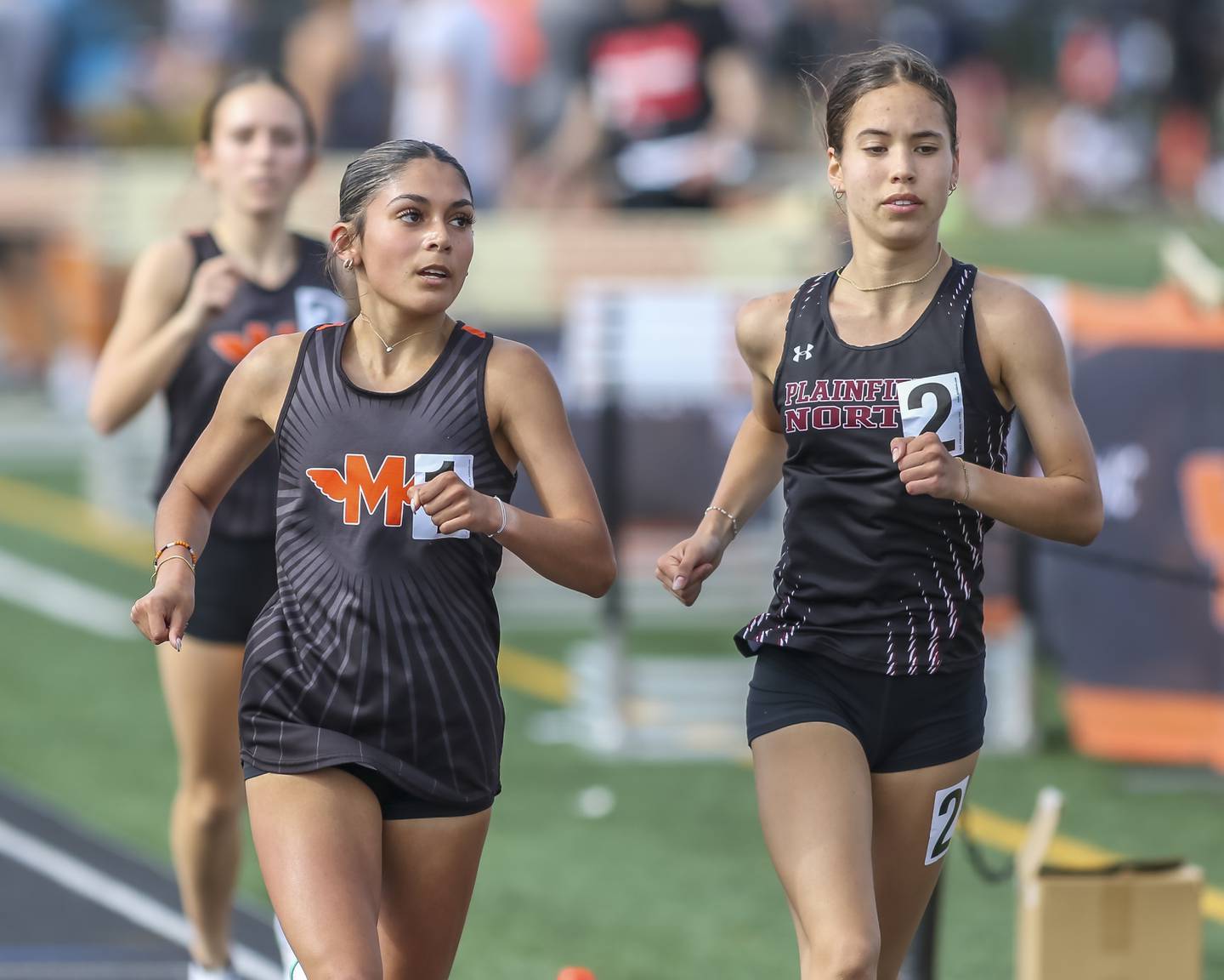 Plainfield North's Marlie Czarniewski (2) and Minooka's Maya Ledesma (1) finished first and second in the 3200m during Southwest Prairie Conference Girls Track and Field Meet Wednesday, May 7, 2025 in Minooka.