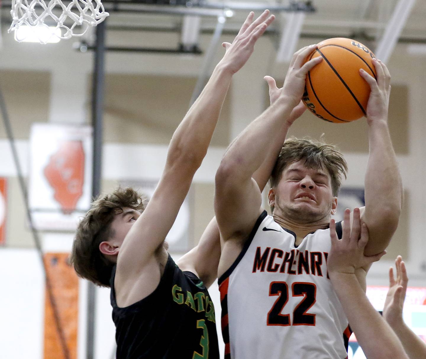 McHenry's Conner McLean (right) grabs a rebound in front of Crystal Lake South's Nick Stowasser during a Fox Valley Conference boys basketball game on Wednesday, Dec. 11, 2024, at McHenry High School.