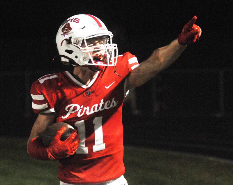 Ottawa's Weston Averkamp points to the student section after scoring a touchdown against Woodstock North at King Field on Friday, Sept. 29, 2023.