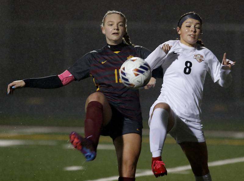 Richmond-Burton’s Jordon Otto and McHenry’s Elena Carlos battle for control of the ball during a non-conference girls soccer match Thursday, March 16, 2023, at Richmond-Burton High.