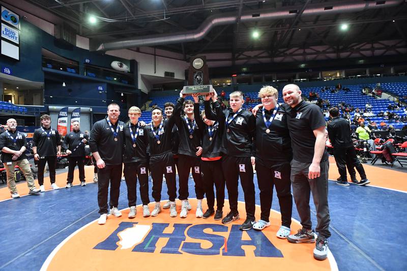 Marian Catholic captains receive the Class 1A third place trophy at the IHSA Dual Team State Finals on Saturday, March 1.