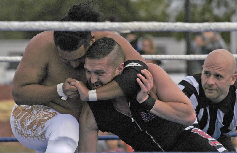 ZOWA wrestler Akuira has  C.J. Esparza in a headlock at the Taco Throwdown Events Sponsored by Rock Falls Tourism. Event at RB&W District September 27th, 2024.
