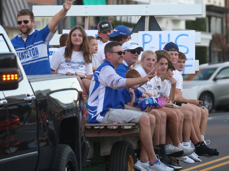 Members of the Princeton High School golf teams ride a float in the Homecoming parade on Thursday, Oct. 3, 2024 downtown Princeton.
