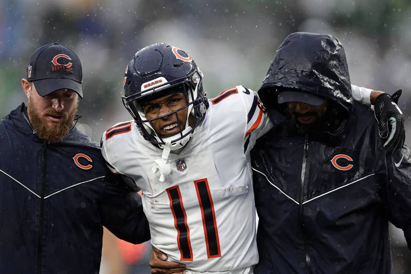 Chicago Bears wide receiver Darnell Mooney is helped off the field against the New York Jets on Sunday, Nov. 27, 2022, in East Rutherford, N.J.