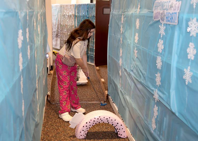 McKenzie Trousdale plays a round of mini golf at the Yorkville Public Library Mini Golf FUN Raiser on Sunday, Feb. 2, 2025 in Yorkville.