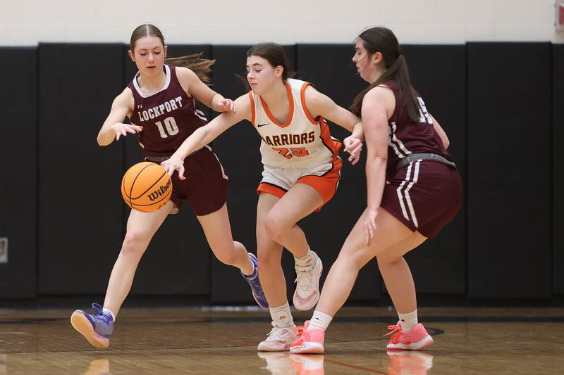 Lincoln-Way West’s Mackenzie Roesner knocks the ball away against Lockport on Tuesday, Feb. 3, 2026 in New Lenox.