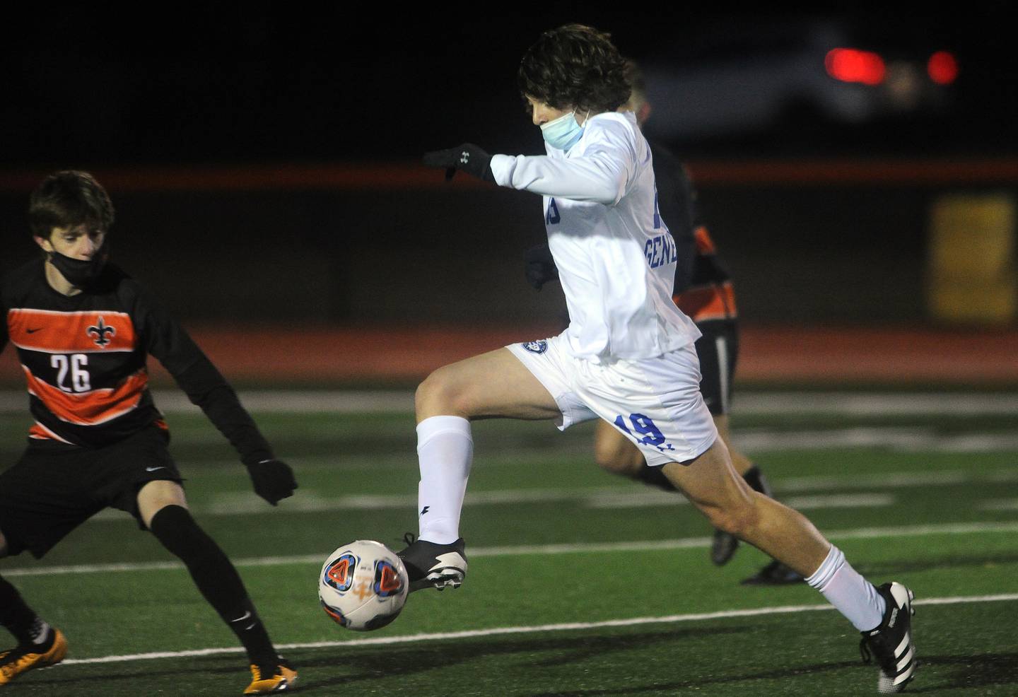 Geneva's Trent Giansanti takes great strides to get away from St. Charles East's Aaron Frost in the first half of  the varsity soccer matchup at St. Charles East High School on Thursday.