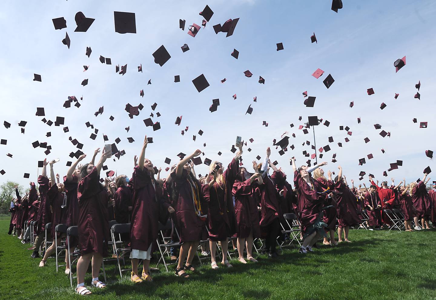 Caps fly as as graduates celebrate their graduation Saturday, May 14, 2022, during the graduation ceremony at Prairie Ridge High School.
