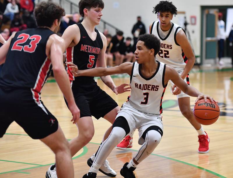 Bolingbrook's Davion Thompson (3) backsteps as Metamora defenders close induring the Jack Tosh Classic championship game on Dec. 30, 2023 at York High School in Elmhurst.
