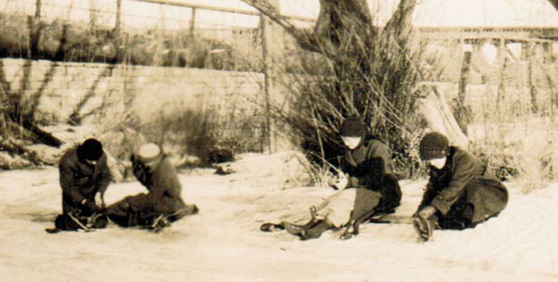 Youngsters lace up their ice skates along the bank of the Fox River in Oswego in about 1920. (Photo provided by the Little White School Museum)