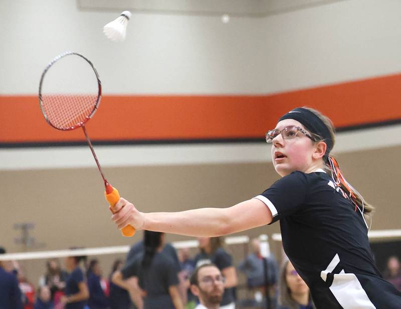 DeKalb junior Carly Kammes hits a backhand during her match against Dana Bogda, a senior from Lincoln-Way West Friday, May 10, 2024, during the IHSA State Badminton Finals at DeKalb High School. Kammes was able to advance after defeating Bogda.