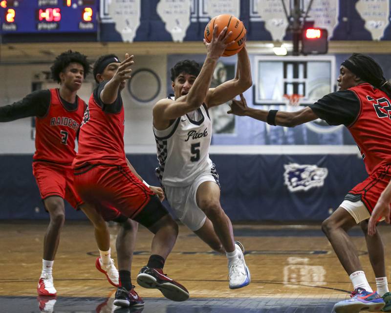 Oswego East's Zayn Manalodi (5) drives down the lane during their basketball game between Bolingbrook at Oswego East Friday, Jan 30, 2026 in Oswego.