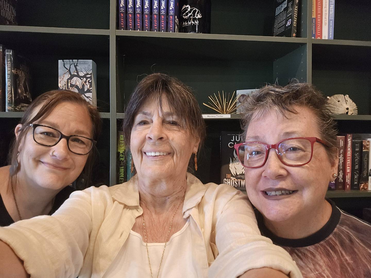 WriteOn Joliet members (from left) Holly Coop, Mauverneen Blevins and Sue Midlock are seen at the adult book fair at the BookBar in Mokena on Saturday, June 28, 2025.