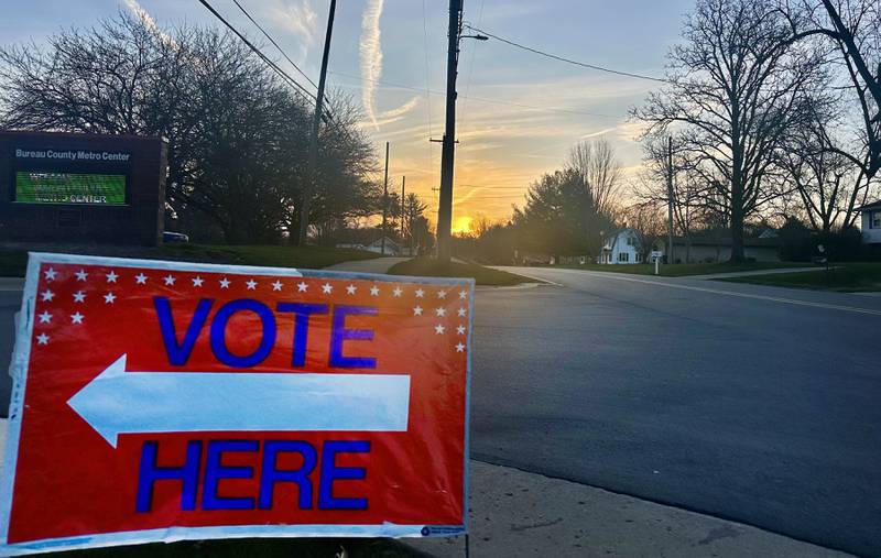 The sun rises over a "vote here" sign at the Bureau County Metro Center on Tuesday, March 19, 2024 in Princeton.