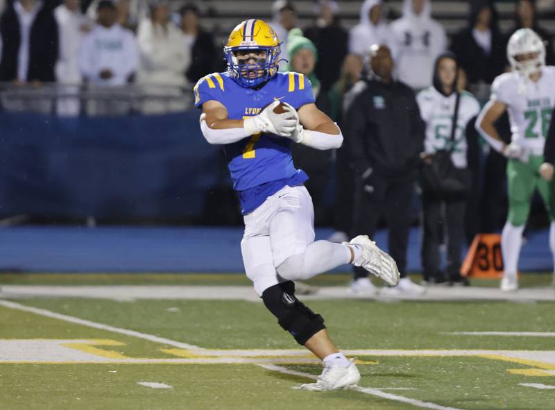 Lyons' Brady Rusk (7) makes a reception during the varsity football first-round 8A playoff game between York and Lyons Township on Friday, Oct. 31, 2025 in Western Springs, IL.