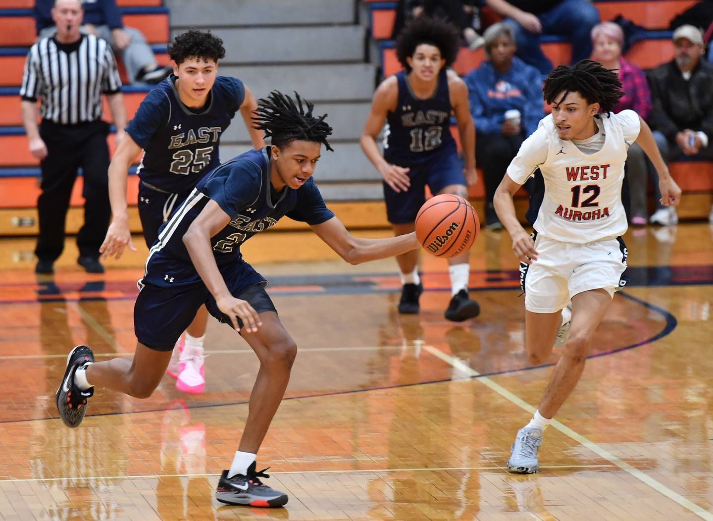 Oswego East's Mason Lockett IV steals the ball from West AuroraÕs Mike Evans (12) during a Hoops for Healing tournament game on Nov. 20, 2023 at Naperville North High School in Naperville.