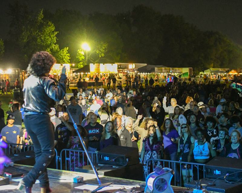 Community members enjoy the music of Prince tribute band The Prince Experience on Thursday June 12, 2025, during PrairieFest held at PrairieFest Park in Oswego.