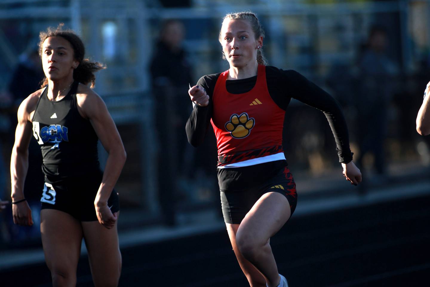 Batavia’s Elizabeth Wende (right) and St. Charles North's Alexzandria Richardson (left) compete in the 100-meter dash during the DuKane Conference Girls Outdoor Championship on Thursday, May 8, 2025 at Glenbard North in Carol Stream.