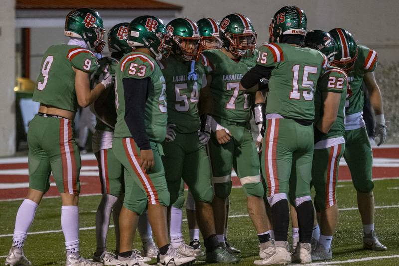 Lasalle Peru Cavaliers discuss strategy during a Kaneland timeout at Howard Fellows Stadium on October 20, 2023.