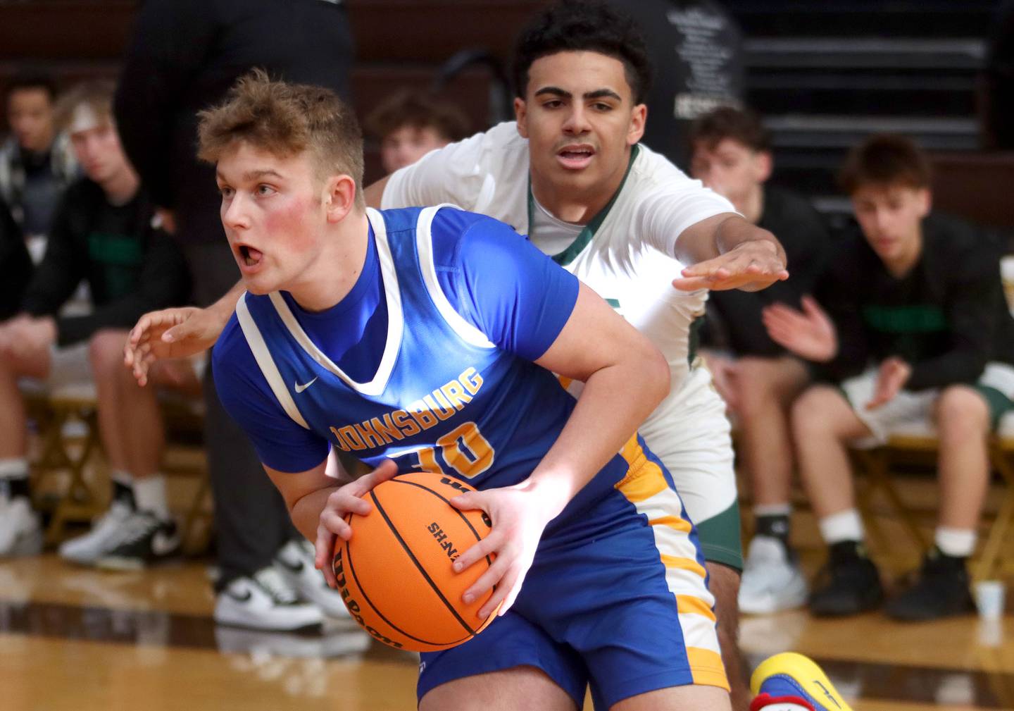 Johnsburg’s Jayce Schmitt, left, gets past Boylan’s Christian Kennedy in varsity boys basketball Hinkle Holiday Classic action on Tuesday, Dec. 23, 2025, at Jacobs High School in Algonquin.
