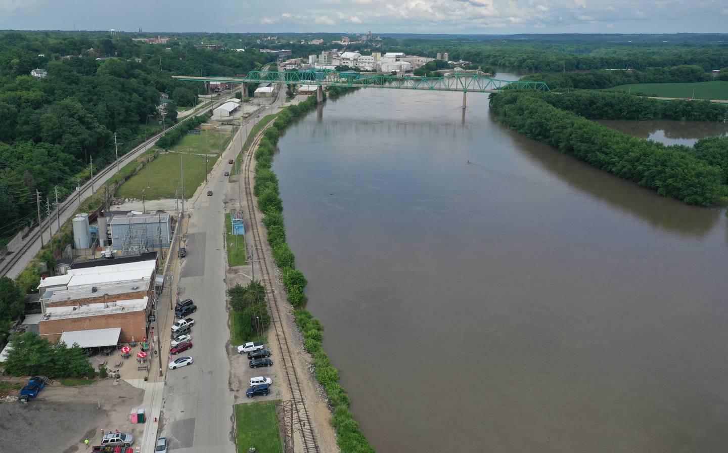 The Illinois River swells up to the top of its banks along Water Street in Peru on Monday June 28, 2021. The Peru fireworks are still scheduled to be launched on the south shore of the river on Saturday July 3, at dusk.