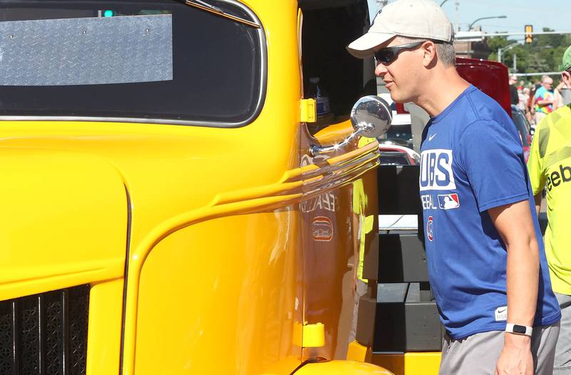 Robert Kirk, from DeKalb, checks out the interior of one of the cars Sunday, July 31, 2022, at the 22nd Annual Fizz Ehrler Memorial Car Show in downtown Sycamore.