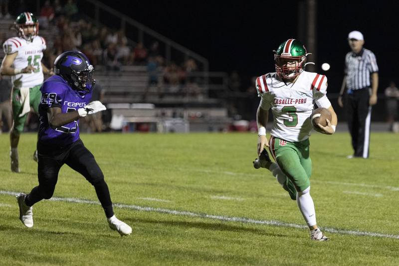 La Salle-Peru's Mason Lynch (3) runs for daylight during Friday's game at Plano.