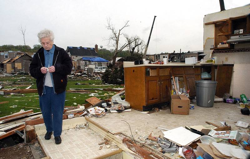 Frances Myers pauses in what used to be her kitchen as she reflects on the cleanup ahead of her. The Utica resident had lived in her home for over 30 years and plans to stay and rebuild after.