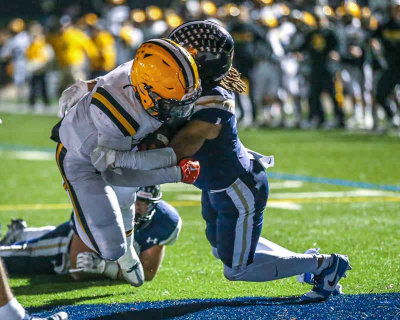 St Laurence's Aaron Ball (6) bowls past IC Catholic Prep's Chance Williams (1) for the winning touchdown during Class 4A third round playoff football game between St Laurence at IC Catholic Prep.  Nov 11, 2023.