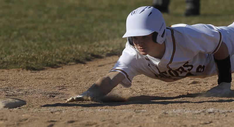 Jacobs’ Nathan Martinko dives bak to first base during a Fox Valley Conference baseball game against Crystal Lake Central Monday, April 10, 2023, at Crystal Lake Central High School.