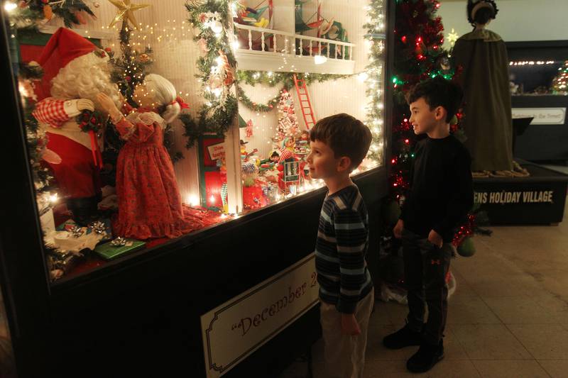 Candace H. Johnson for Shaw Local News Network
Bradley Porch, 8, of Antioch and his brother, Alex, 9, look at the holiday scenes featured in one of the oversized shadowboxes on display at the Kringle’s Christmas Village indoor showroom on Orchard Street in Antioch. Admission is free and it runs from Thanksgiving through New Year’s Day. (11/28/22)