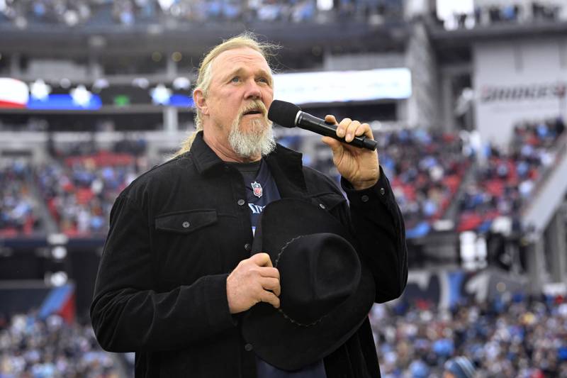 Trace Adkins sings the national anthem before an NFL football game between the Tennessee Titans and the Carolina Panthers Sunday, Nov. 26, 2023, in Nashville, Tenn. (AP Photo/John Amis)