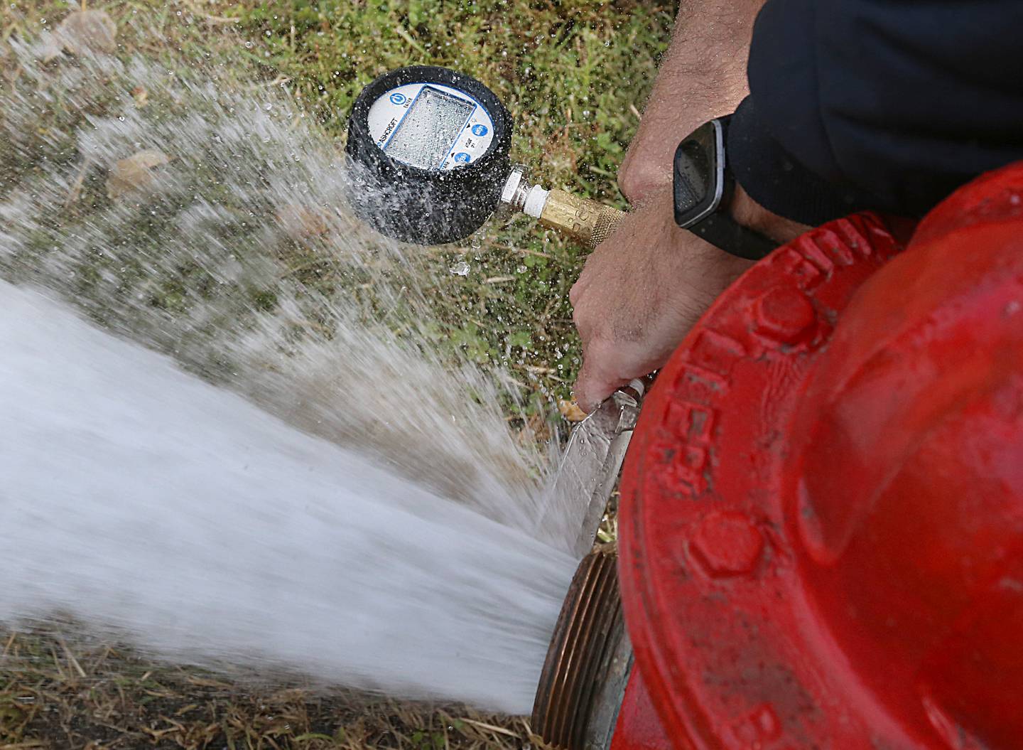 Utica firefighters use a Pitot Gauge to measure the flow of the output of water on a fire hydrant on Monday Oct. 17, 2022 at Neighbors Park in Utica.