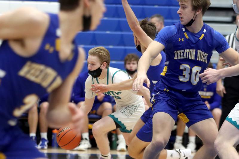 Woodstock North’s Rex White moves the ball against Wheaton North during MLK Tournament action at Burlington Central High School Saturday morning.