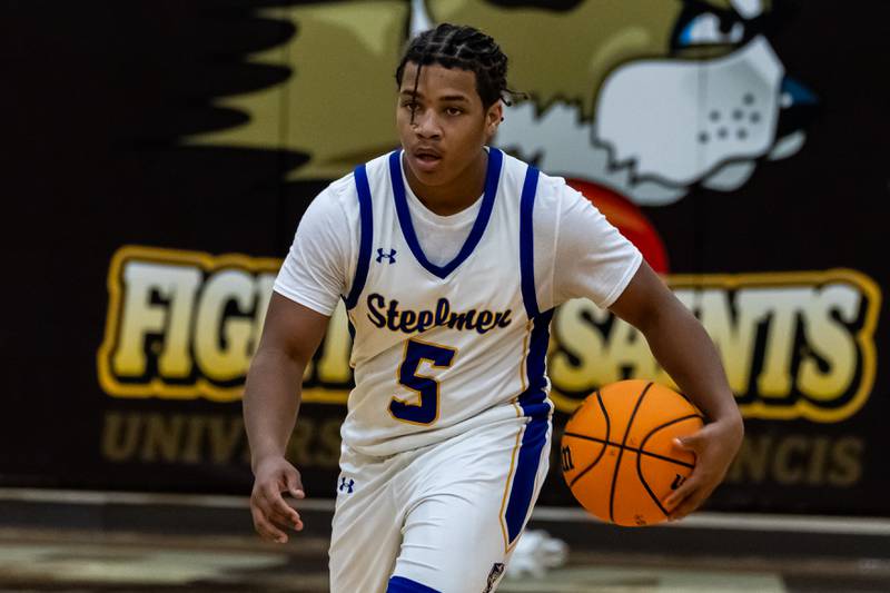Joliet Central's Michael Stokes dribbles down court during a WJOL Thanksgiving Classic Boys Basketball game against Lockport at the University of St. Francis’s Pat Sullivan Center in Joliet on Nov. 24, 2025.