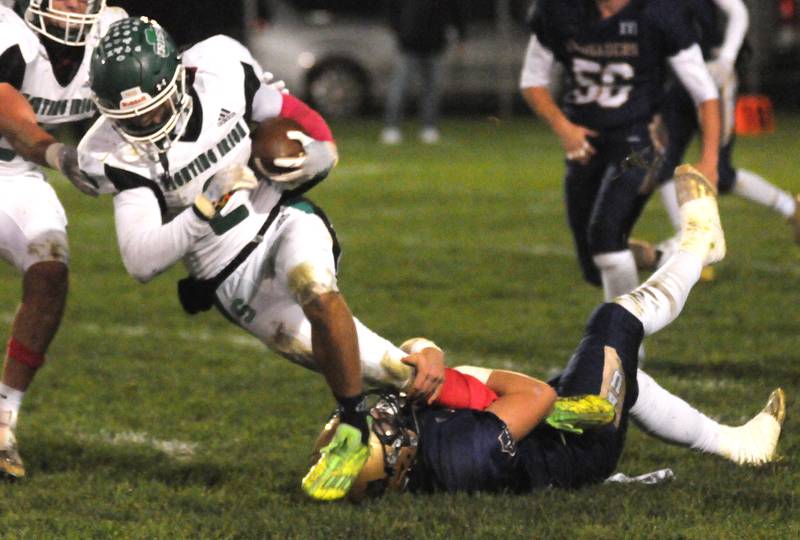 Seneca's Asher Hamby (2) reaches for more yards as Marquette's Jason Higgins takes him down at Gould Stadium on Friday, Oct. 6, 2023.