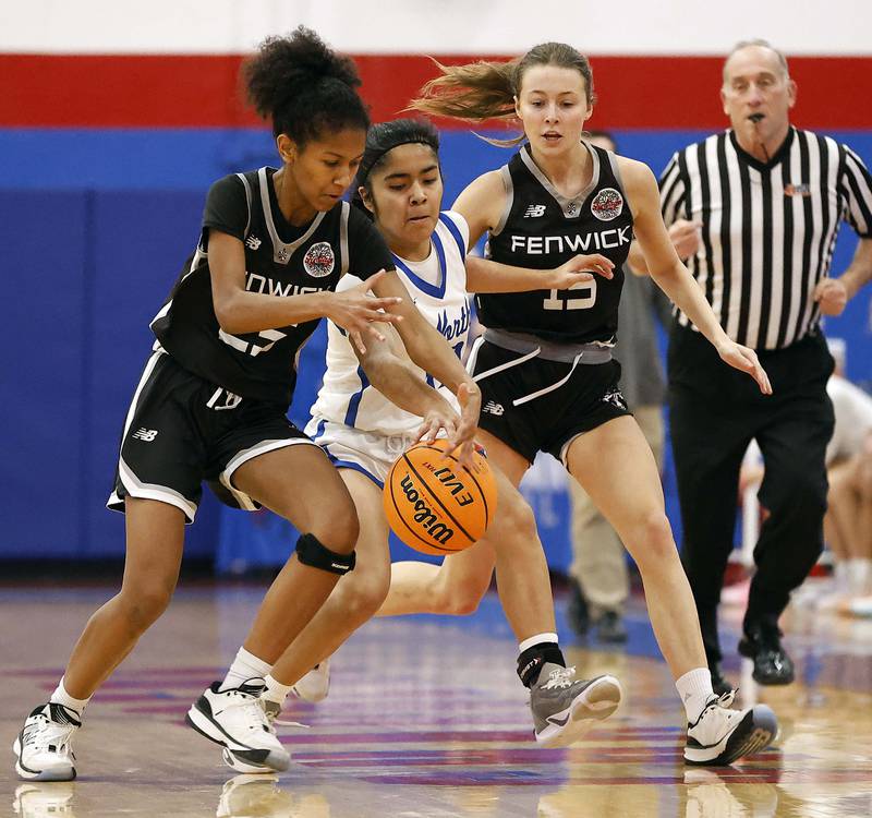 Fenwick's Eleanor Gibson (25) and Cammie Molis (15) pursue St. Charles North's Lelanie Posada (30) during the Dundee-Crown High School 41st Annual Komaromy Classic Friday, Dec. 27, 2024 in Carpentersville.