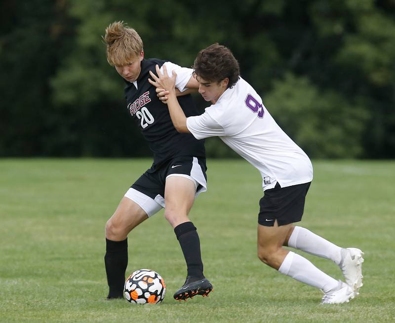 Hampshire's Charles Terriquez pushes Prairie Ridge's Carter Fredrikson as he tries to get the ball during a Fox Valley Conference soccer match Tuesday, Sept. 19, 2023, at Prairie Ridge High School in Crystal Lake.