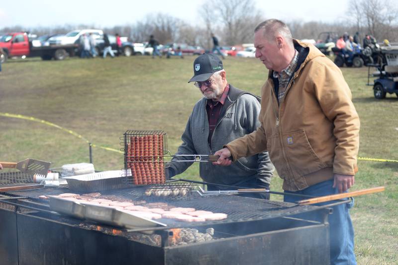 Polo Lions Club members Mark Bocker and Paul Wiemken were on grill duty at the Lions concession stand at the Hazelhurst Spring Consignment Auction west of Polo on Saturday, April 5, 2025.