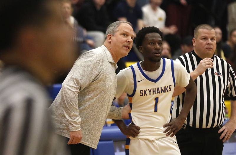 Johnsburg Head Coach Mike Toussaint talks with Jarrel Albea during the IHSA Class 2A Johnsburg Regional Championship boys basketball game against Richmond-Burton on Friday, February, 27, 2026, at Johnsburg High School.