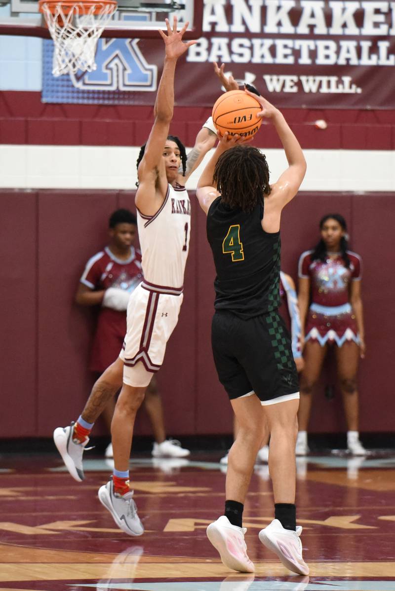 Kankakee's Lincoln Williams, left, leaps to block a shot from Waubonsie Valley's Kristopher Mporokoso during a game at Kankakee Monday, Feb. 16, 2026.