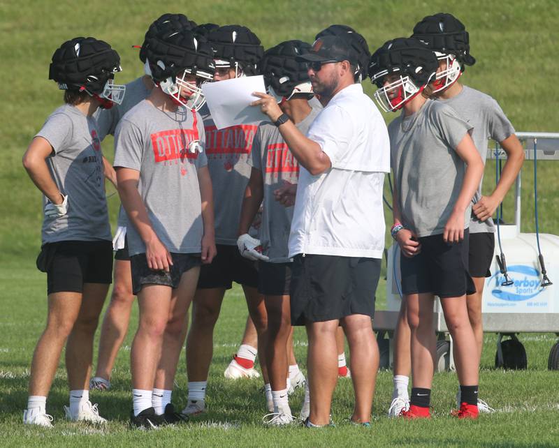 Ottawa head football coach Chad Gross talks to his team between plays while playing St. Bede during a 7-on-7 meet against Ottawa on Monday, July 17, 2023 at Ottawa High School.