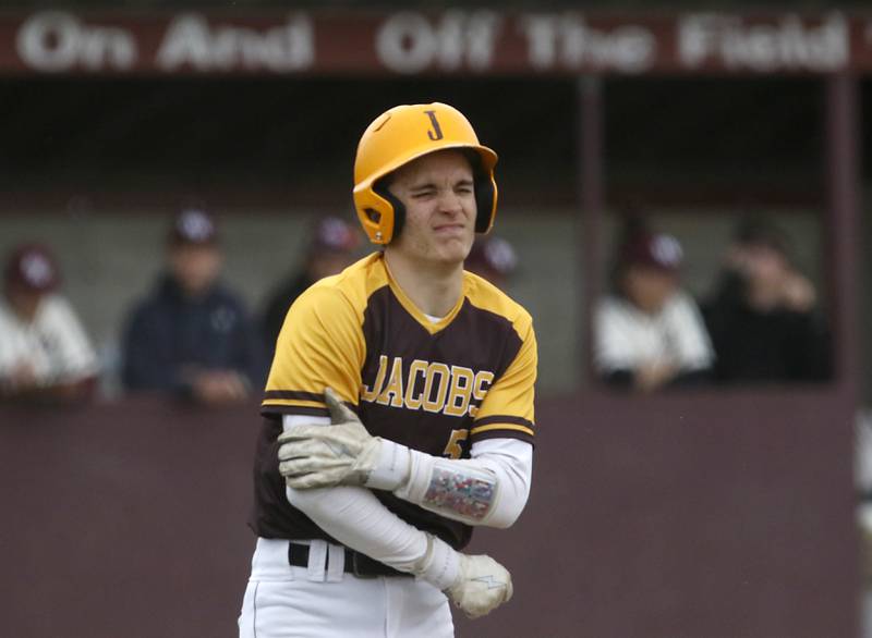 Jacobs's Peter Mitchell holds his arm as he walks to first base after being hit by a pitch during a Fox Valley Conference baseball game Friday, April 29, 2022, between Prairie Ridge and Jacobs at Prairie Ridge High School.