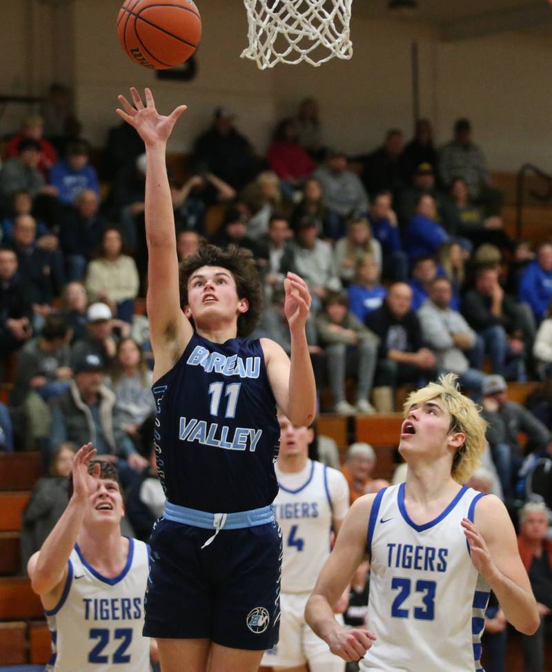 Bureau Valley's Logan Philhower runs in the lane to score on a layup as Princeton's Evan Driscoll and Noah LaPorte defend on Tuesday, Jan. 30, 2024 at Princeton High School.