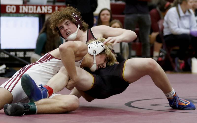 Richmond-Burton’s Maxwell Martin tries to get out of the grasp of Wheaton Academy,’s Chasen Kazmierczak in the 157-pound championship match of the IHSA 1A Marengo Wrestling Regional on Saturday, Feb. 8, 2025, at Marengo High School.
