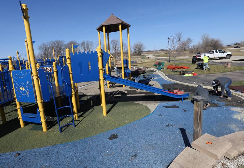 Workers with Team Reil Inc. removes pieces of the surface of the playground at Rotary Park on Monday, March 11, 2024 in La Salle. The playground will be re-surfaced and completed on March 25. The playground will be closed until work is finished.