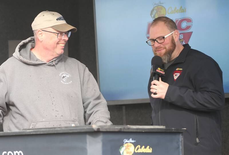 Dave Hall of Peru, talks with tournament director Jeff Kelm, during the annual Masters Walleye Circuit tournament on Friday, March 21, 2025 at the Spring Valley Boat Club.