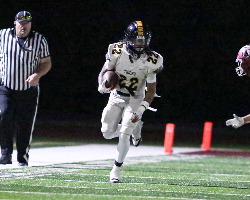 Joliet West's LaDainian Tucker (22) runs from the Morris defense during football game between Joliet West at Morris.  Sept 1, 2023.