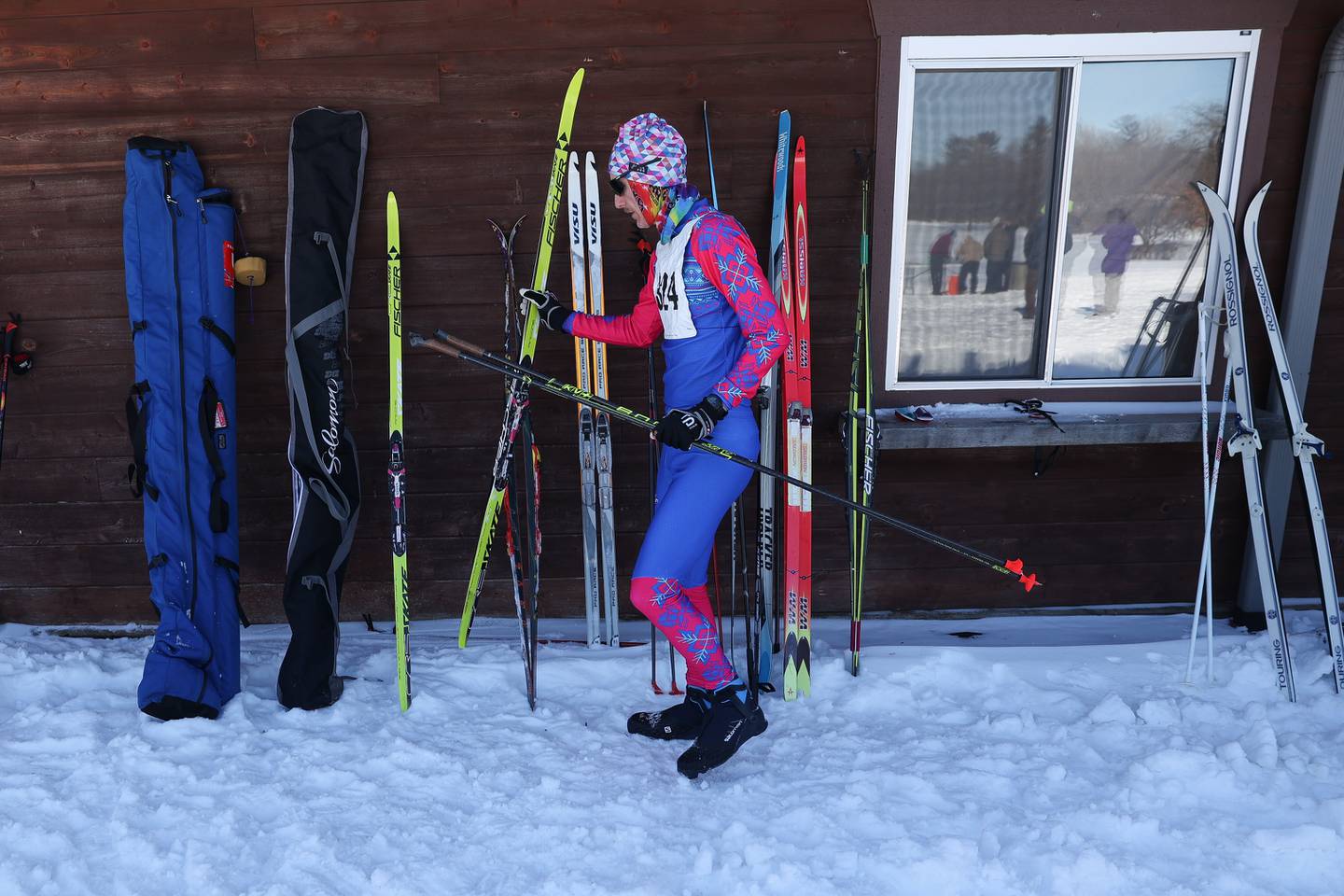 A skier puts up his skis after finishing the Joliet Nordic Ski Club 12k race on Saturday, Jan. 20th, 2024 at Woodruff Golf Course in Joliet.
