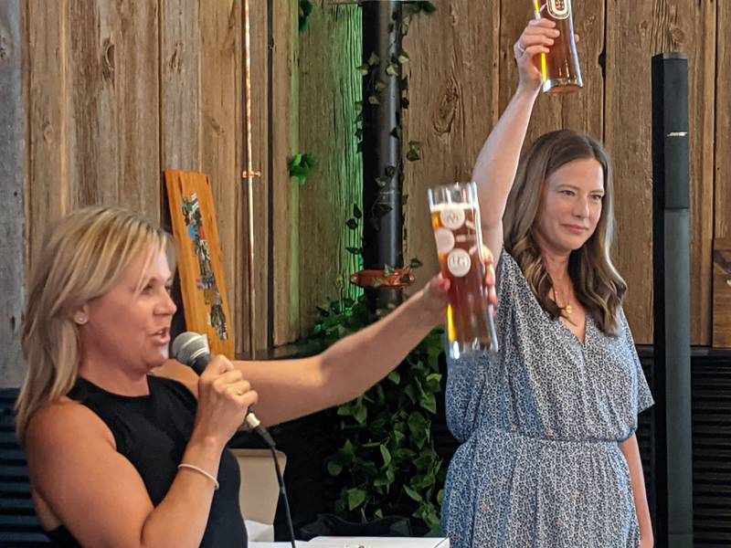 St. Charles Mayor Lora Vitek leads the crowd at Riverlands Brewing Company in a toast of the the first-ever St. Charles collaboration beer. Standing next to her is St. Charles Business Alliance Executive Director Jenna Sawicki.